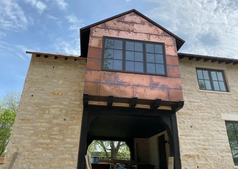 Copper metal panel facade on a stone building for Metal Roof Coating in Headland